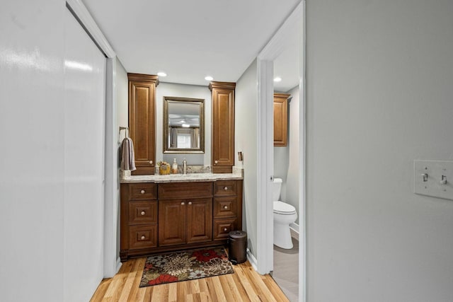 5025 Hillsboro Pike Unit 20E, Nashville, TN 37215 - bathroom with wood finished floors, toilet, recessed lighting, and vanity