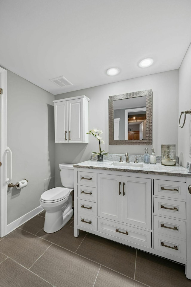 5025 Hillsboro Pike Unit 20E, Nashville, TN 37215 - bathroom with baseboards, visible vents, toilet, and vanity