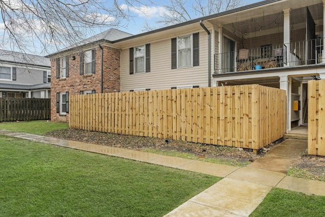 5025 Hillsboro Pike Unit 20E, Nashville, TN 37215 - exterior space with a yard, a balcony, brick siding, and fence