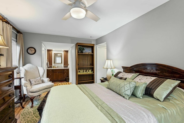 5025 Hillsboro Pike Unit 20E, Nashville, TN 37215 - bedroom featuring ceiling fan, wood finished floors, and connected bathroom