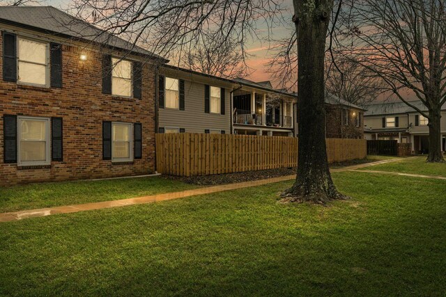 5025 Hillsboro Pike Unit 20E, Nashville, TN 37215 - view of side of home with brick siding, fence, and a yard