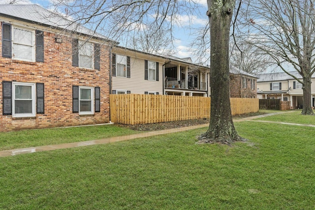 5025 Hillsboro Pike Unit 20E, Nashville, TN 37215 - view of front facade with a front yard, fence, and brick siding