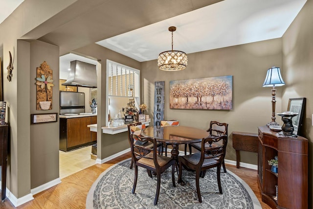 5025 Hillsboro Pike Unit 20E, Nashville, TN 37215 - dining room featuring baseboards, a chandelier, and light wood finished floors