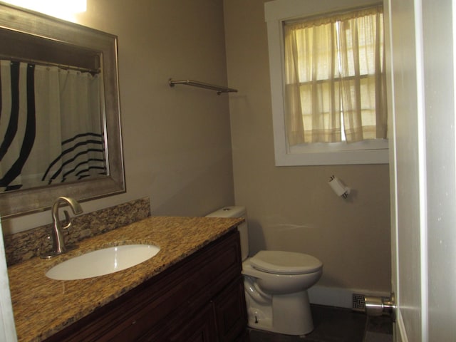 full bath featuring toilet and vanity