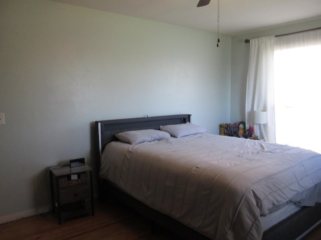 bedroom with dark wood-type flooring and a ceiling fan