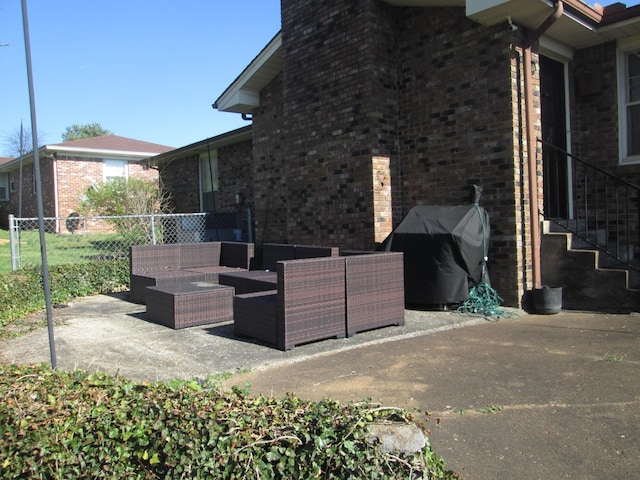 view of patio / terrace with fence, outdoor lounge area, and a grill