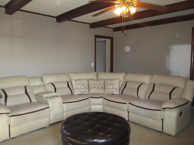living area featuring carpet flooring, ceiling fan, and beamed ceiling