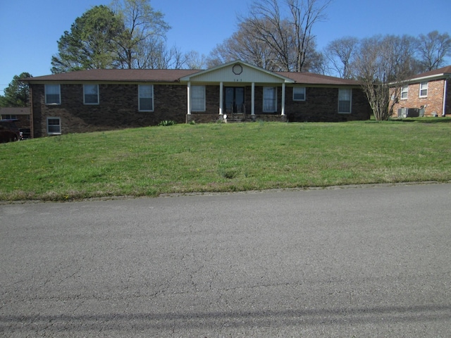 ranch-style house with brick siding and a front lawn