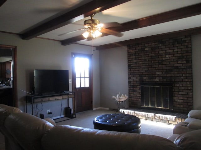 living room with a brick fireplace, baseboards, carpet floors, beam ceiling, and a ceiling fan