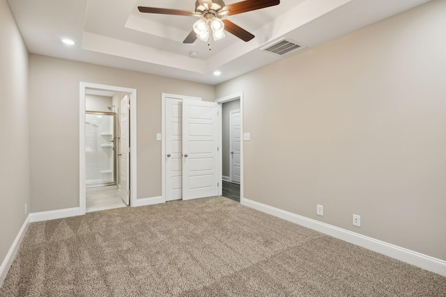 946 Tufnel Dr, Clarksville, TN 37040 - unfurnished bedroom featuring visible vents, carpet, baseboards, connected bathroom, and a tray ceiling