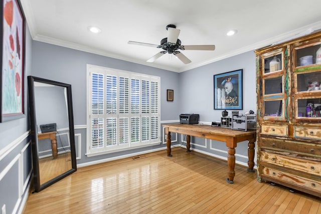 office area with a ceiling fan, ornamental molding, and light wood-style floors