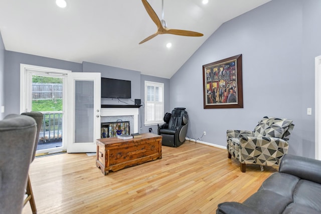 living room featuring a ceiling fan, hardwood / wood-style flooring, a fireplace, and recessed lighting