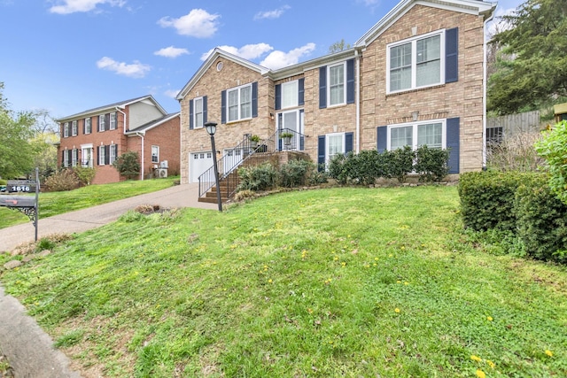 raised ranch with brick siding, a garage, concrete driveway, and a front yard