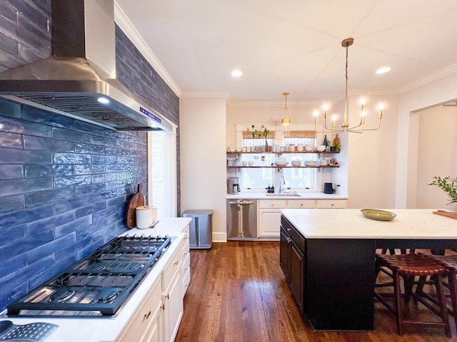 336 Chesterfield Ave, Nashville, TN 37212 - kitchen with light countertops, crown molding, a sink, gas cooktop, and wall chimney range hood