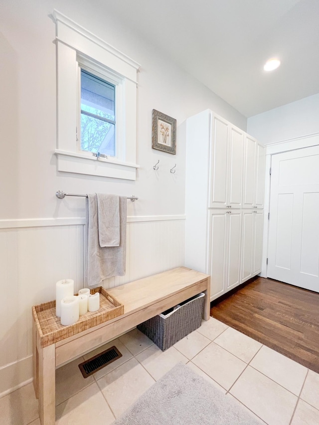 336 Chesterfield Ave, Nashville, TN 37212 - mudroom featuring a wainscoted wall, visible vents, and dark tile patterned flooring
