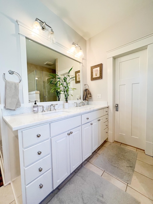 336 Chesterfield Ave, Nashville, TN 37212 - bathroom featuring a stall shower, tile patterned floors, double vanity, and a sink