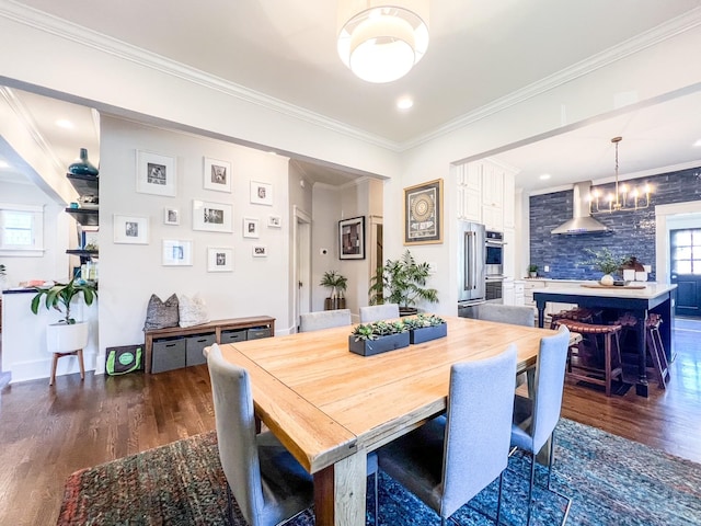 336 Chesterfield Ave, Nashville, TN 37212 - dining area featuring ornamental molding, dark wood-type flooring, baseboards, and a notable chandelier