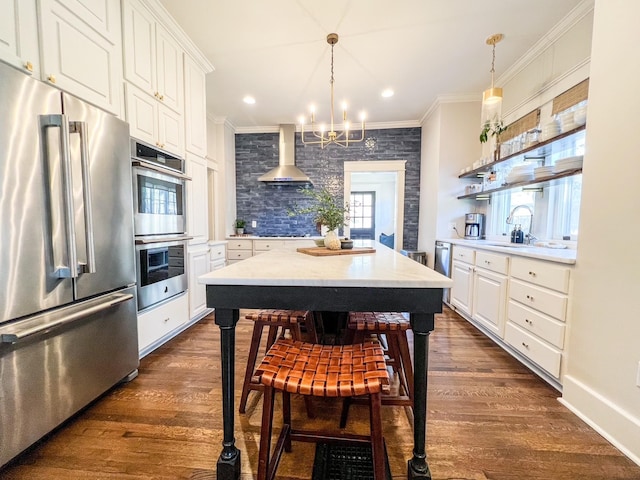 336 Chesterfield Ave, Nashville, TN 37212 - kitchen with wall chimney exhaust hood, open shelves, crown molding, and appliances with stainless steel finishes
