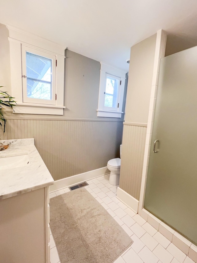 336 Chesterfield Ave, Nashville, TN 37212 - bathroom featuring a stall shower, toilet, vanity, wainscoting, and visible vents