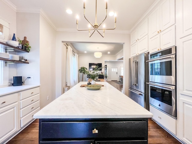 336 Chesterfield Ave, Nashville, TN 37212 - kitchen featuring white cabinetry, crown molding, an inviting chandelier, dark wood-style flooring, and stainless steel appliances