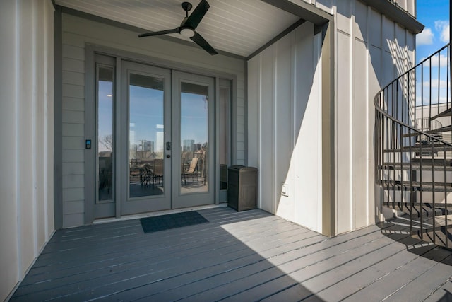deck with a view of city, french doors, and a ceiling fan