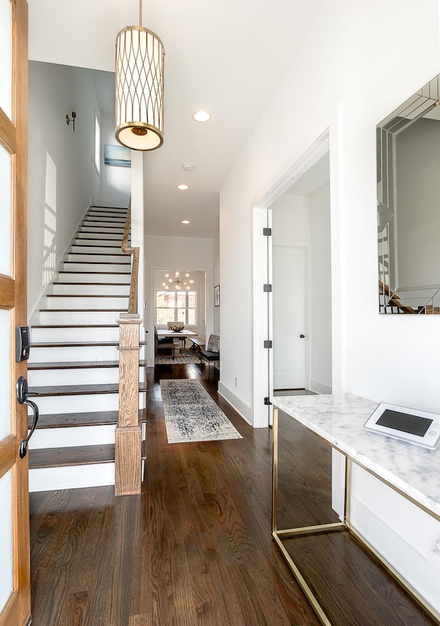 foyer entrance featuring recessed lighting, baseboards, stairs, and wood finished floors