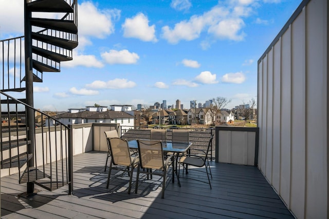 wooden terrace featuring outdoor dining space and a residential view