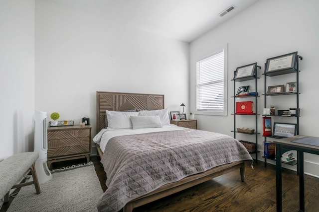 bedroom featuring visible vents and wood finished floors