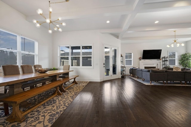 dining room with a healthy amount of sunlight, dark wood-style flooring, beamed ceiling, and a chandelier