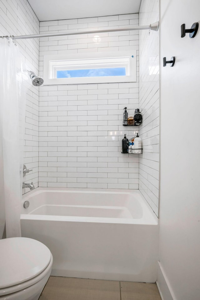 full bath featuring shower / tub combo with curtain and toilet