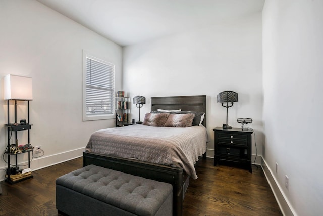 bedroom with baseboards and wood finished floors