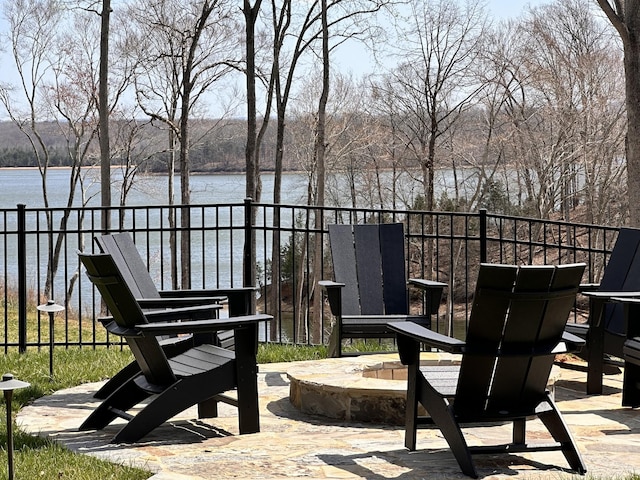 view of patio featuring a fire pit and a water view