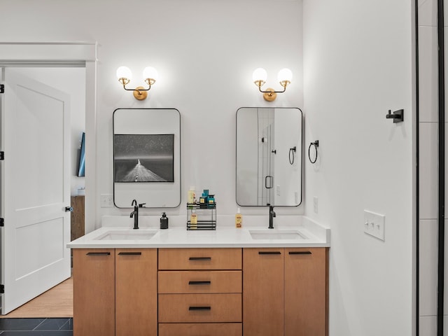 full bathroom featuring double vanity and a sink