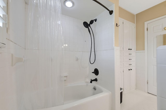 bathroom with tile walls and shower / bath combination with curtain