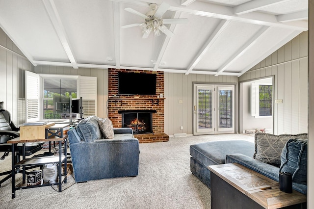 carpeted living area with a healthy amount of sunlight, a fireplace, a ceiling fan, and lofted ceiling with beams