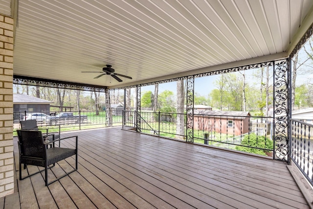 wooden terrace featuring ceiling fan