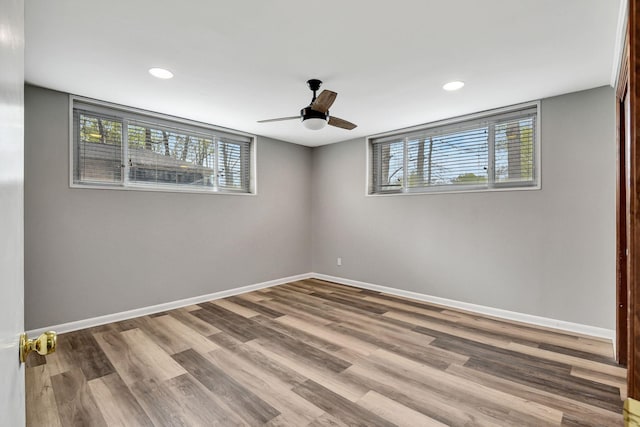 empty room with wood finished floors, baseboards, a ceiling fan, and recessed lighting