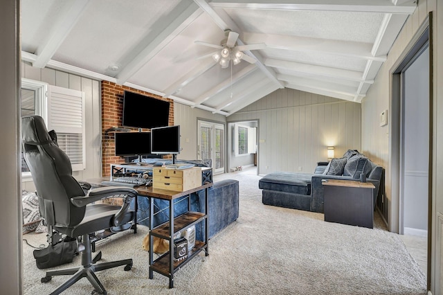 office area with ceiling fan, lofted ceiling with beams, wooden walls, and carpet floors
