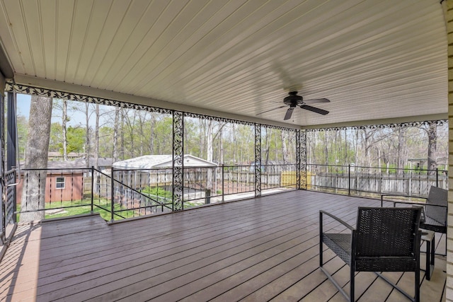 deck featuring an outbuilding and ceiling fan