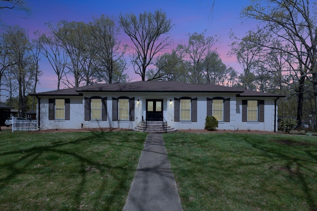 ranch-style home with brick siding and a front lawn