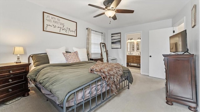 bedroom with light carpet, ensuite bathroom, and a ceiling fan