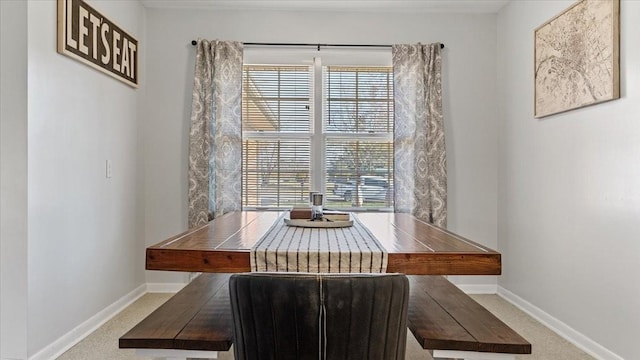 dining room featuring baseboards and carpet floors