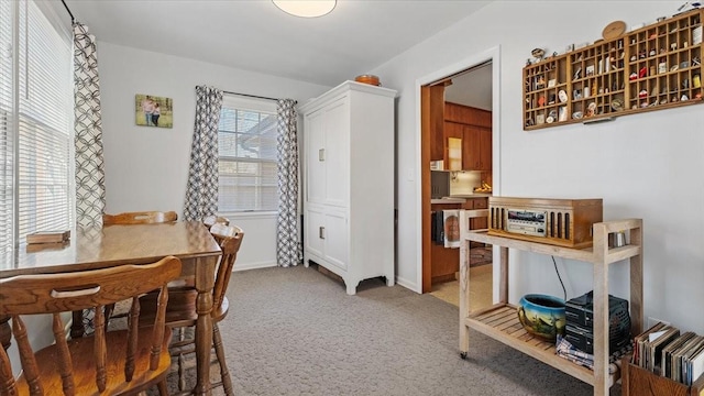 dining room featuring light carpet