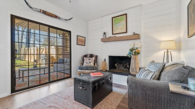 living area featuring a fireplace and wood finished floors