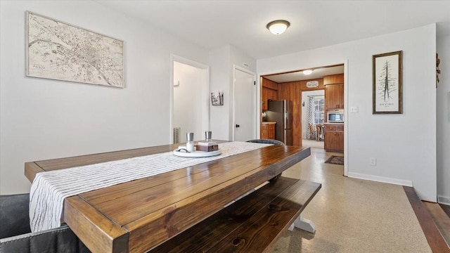 dining area featuring baseboards