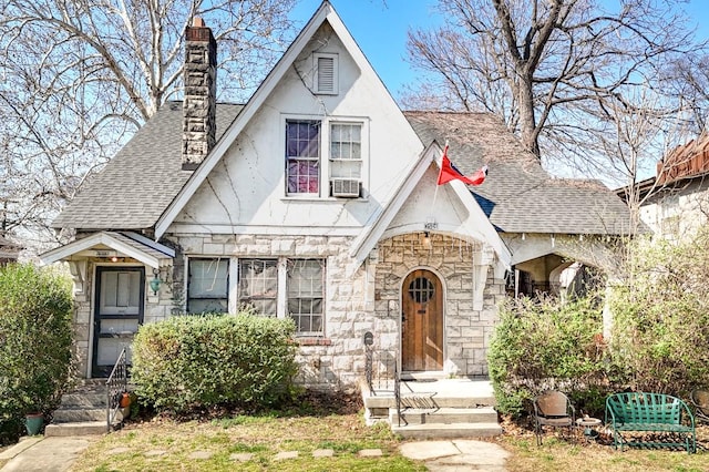 3524 W End Ave, Nashville, TN 37205 - tudor house featuring stone siding, a chimney, roof with shingles, stucco siding, and cooling unit