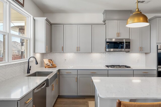 576 Nottingham Ave, Hendersonville, TN 37075 - kitchen with gray cabinetry, a sink, tasteful backsplash, and appliances with stainless steel finishes