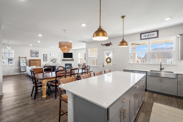 576 Nottingham Ave, Hendersonville, TN 37075 - kitchen featuring gray cabinets, decorative backsplash, a kitchen island, a sink, and dark wood-style floors