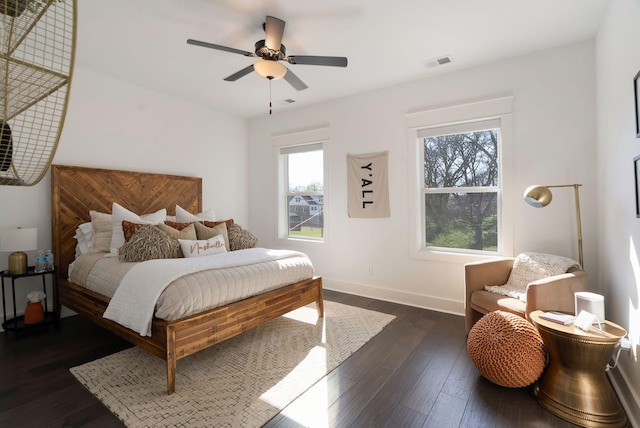 bedroom with dark wood-type flooring, baseboards, and a ceiling fan
