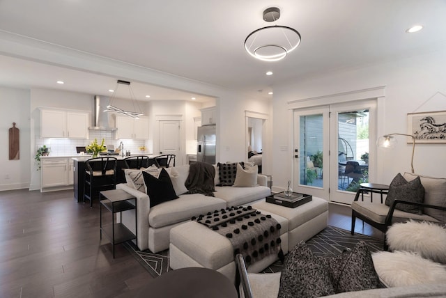 living area with dark wood finished floors, recessed lighting, and baseboards